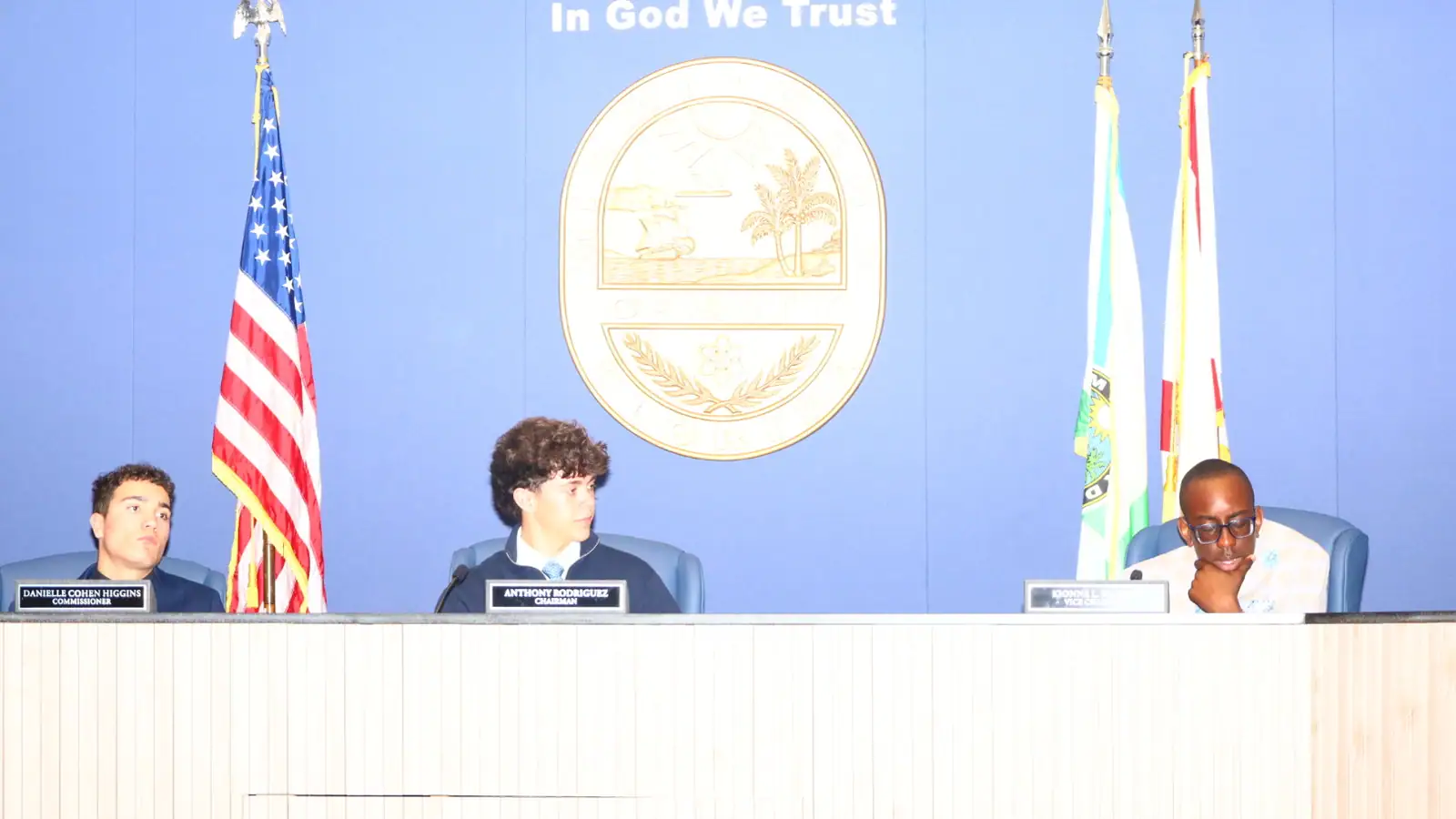 A fellow presides from the dais during the Board of County Commissioners simulation.