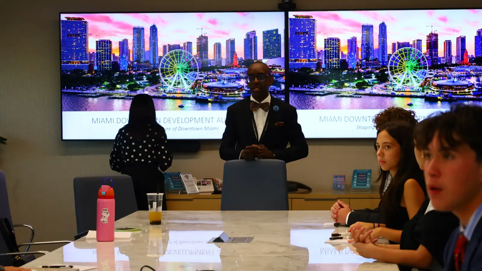 Fellows analyze the Brickell economy from a boardroom above it.