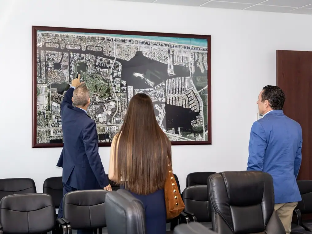 Studying a municipal planning map with city staff.
