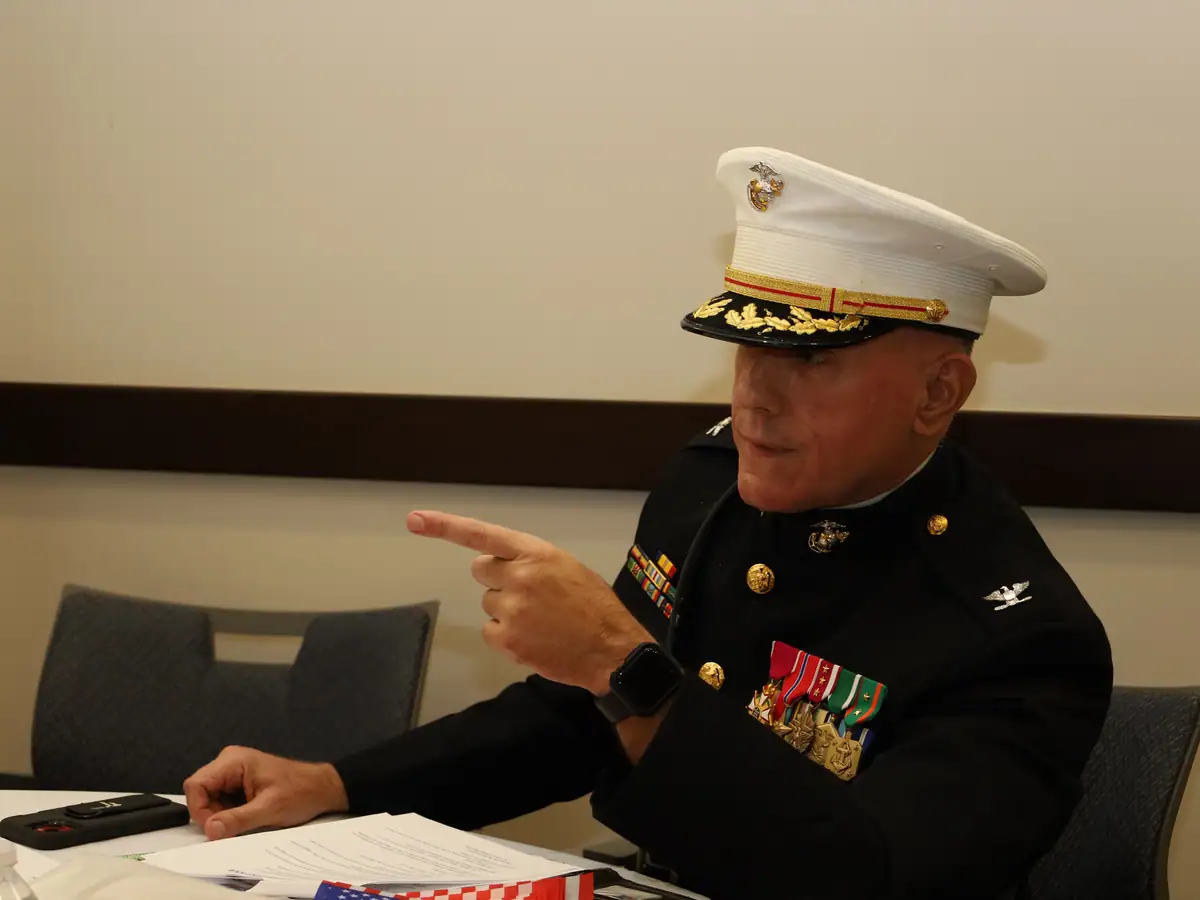 A guest from public service takes questions from a student table.