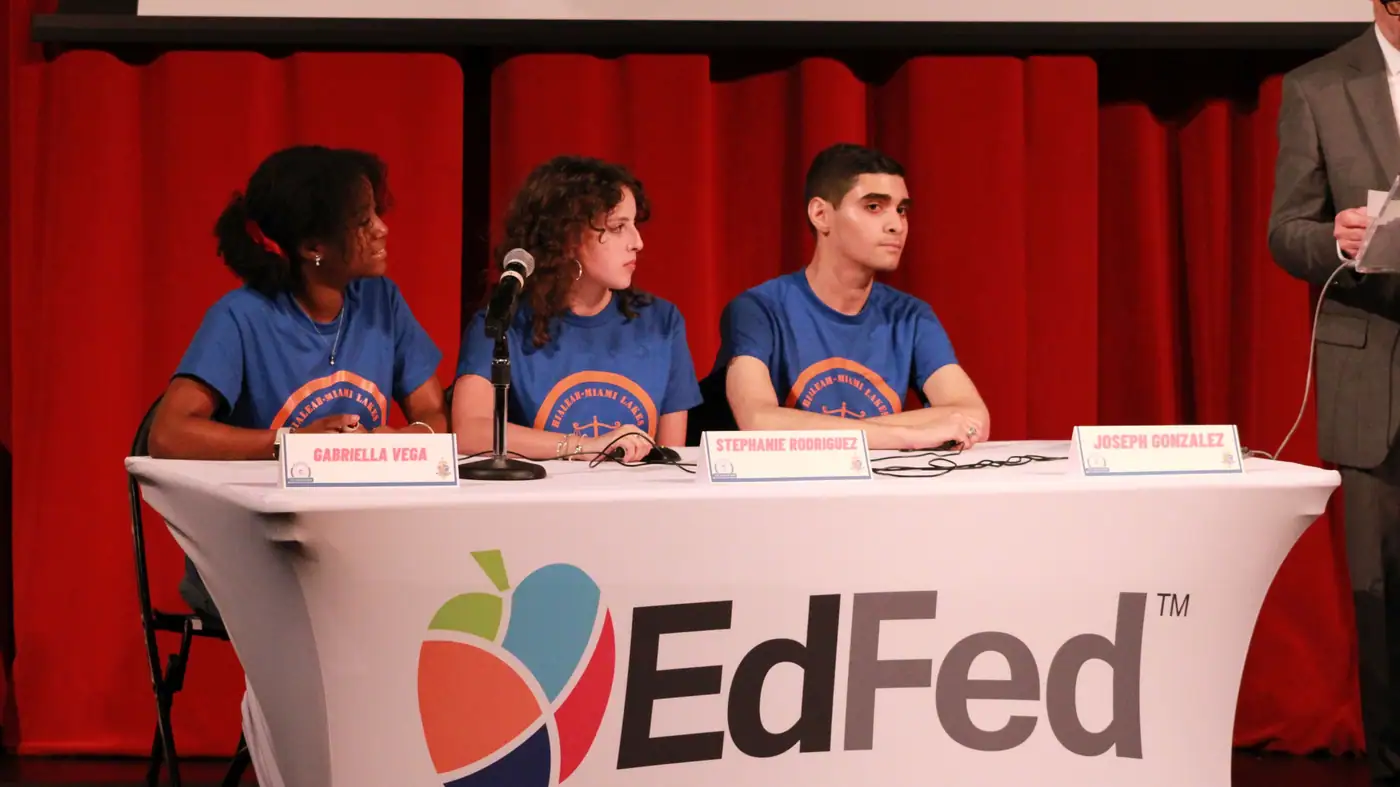A school team works the buzzers during competition.