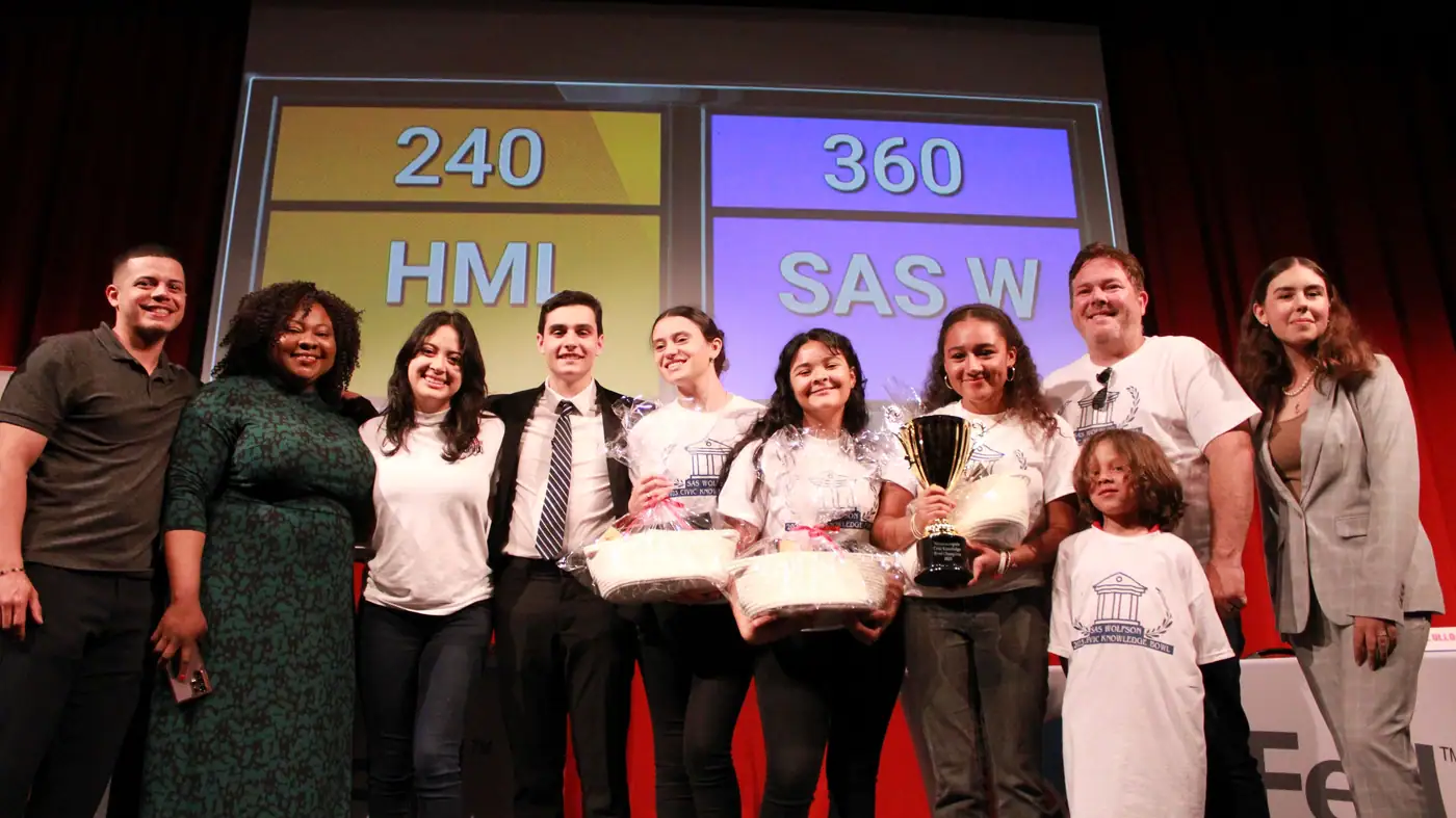 A winning school team recognized on stage.