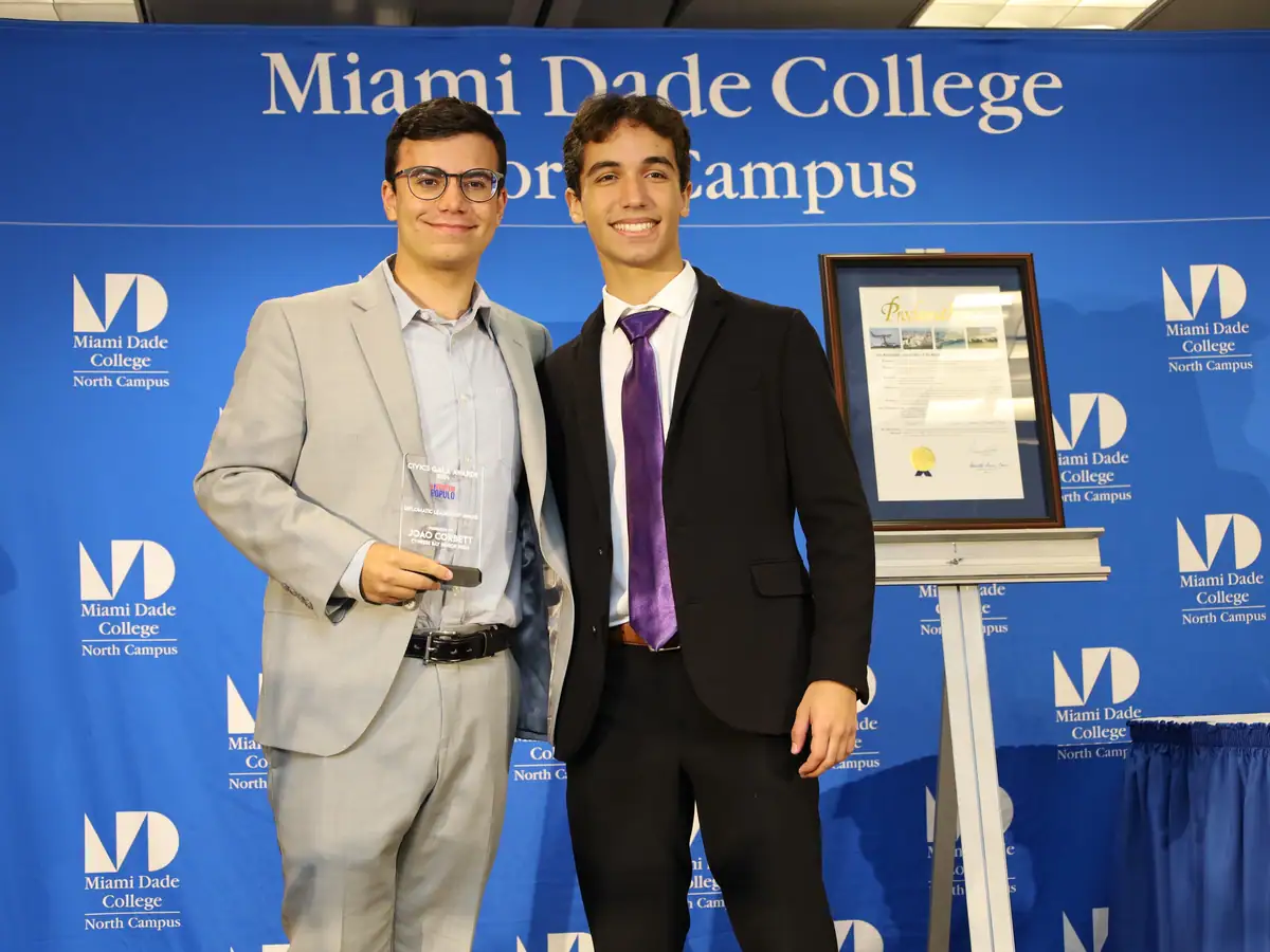 A student receives recognition from a community partner.