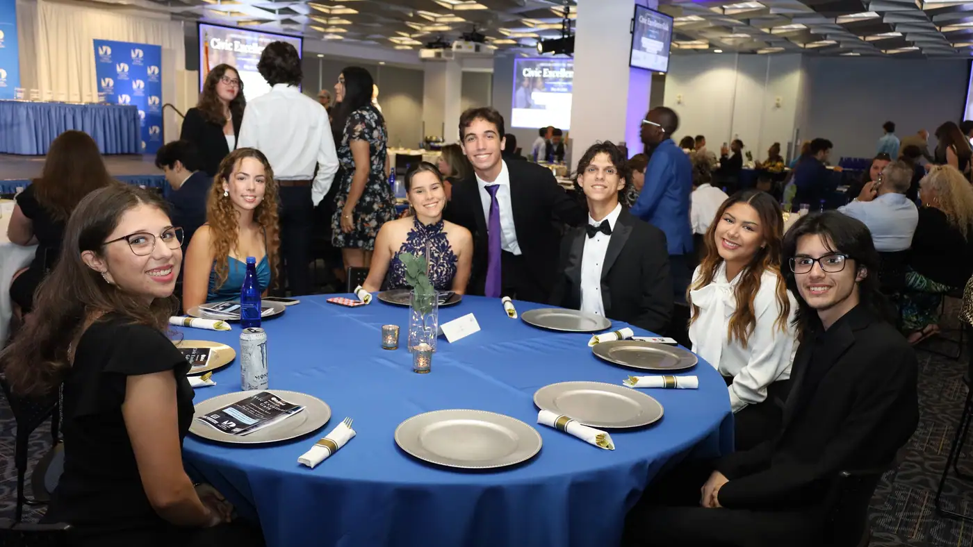 Guests, families and partners fill the room.
