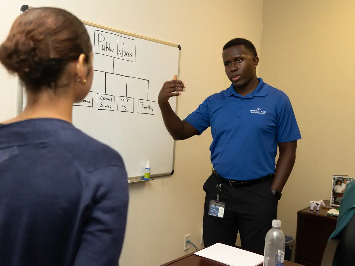 Municipal staff brief a student on the department before the day begins.
