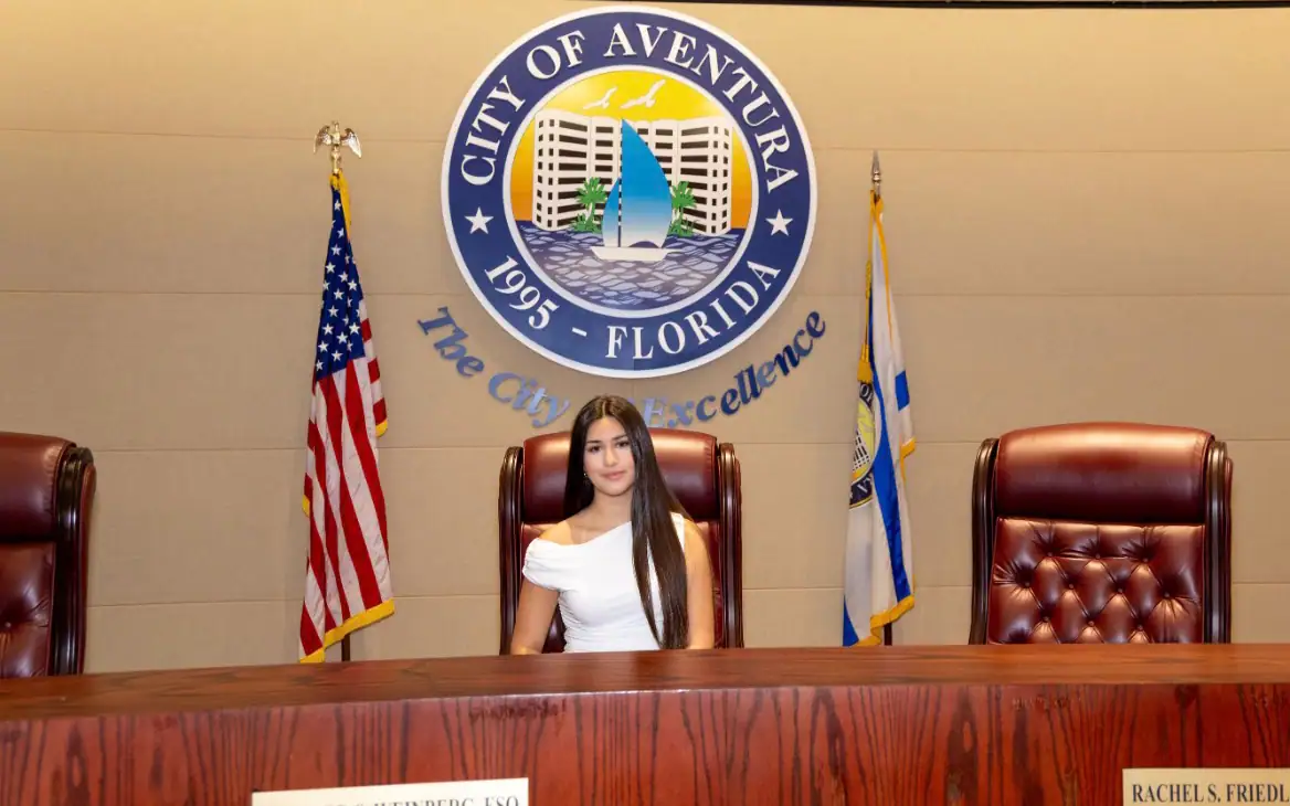 A student seated at the commission dais in Aventura.
