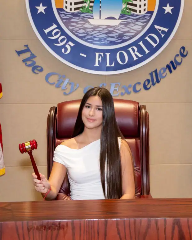 The gavel passes to a student for the day.